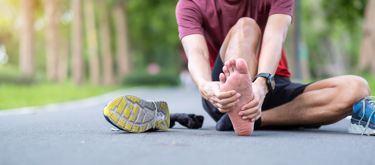 Young adult male with his muscle pain during running. runner man having leg ache due to Plantar fasciitis. Sports injuries and medical concept